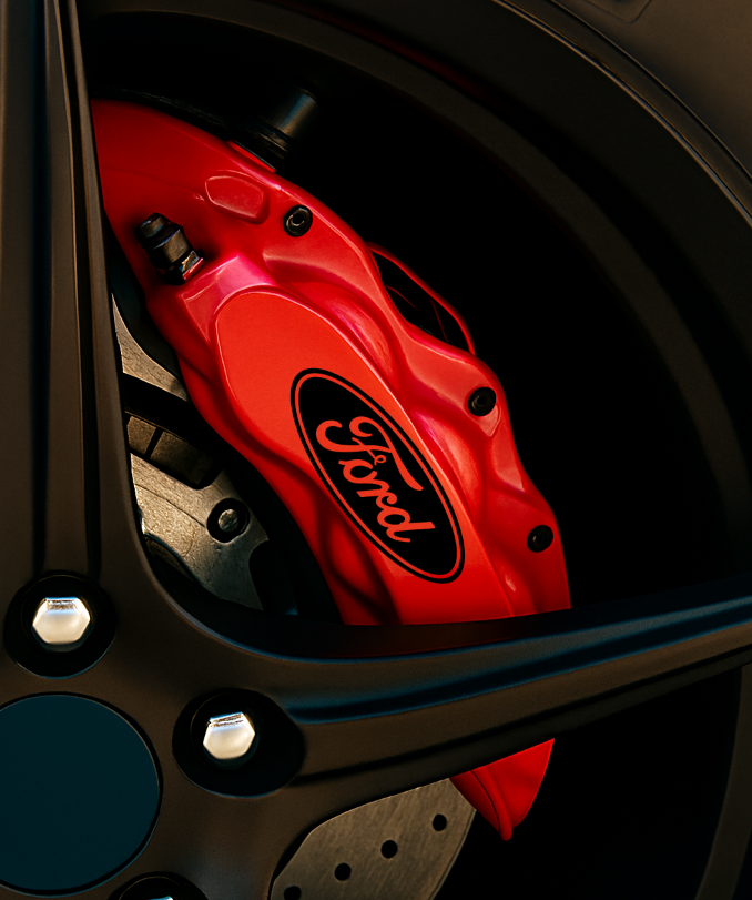 Red Ford brake caliper on a car wheel with 'Racetrackhub' logo.