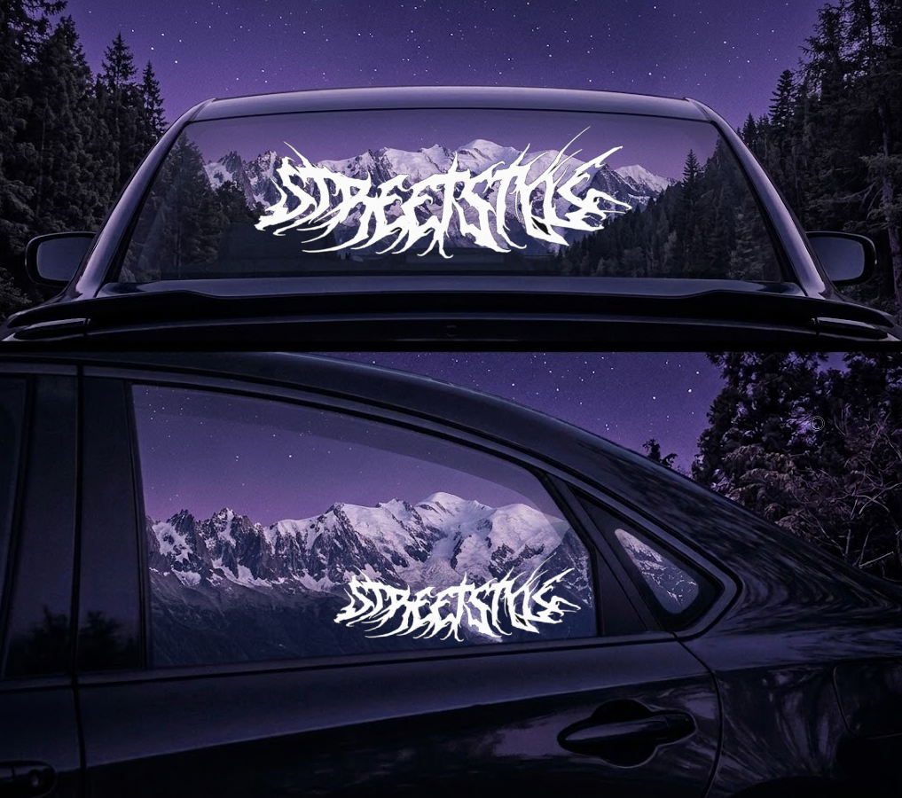 Car with Streetlife decal on windows and rear windshield at night with mountain view