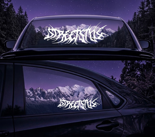Car with Streetlife decal on windows and rear windshield at night with mountain view